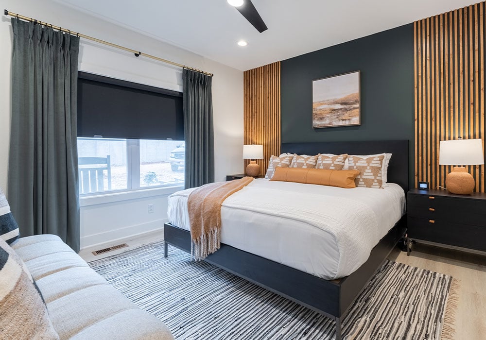 Black roller shades in a bedroom