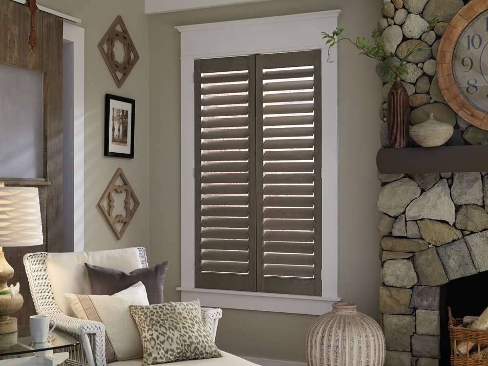 brown plantation shutters in sitting room