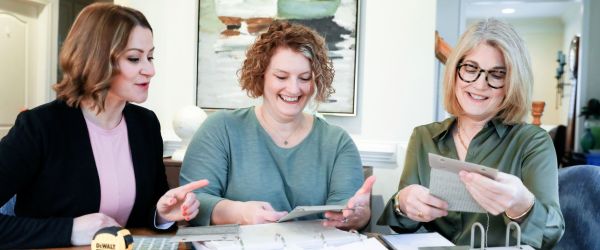 three women looking at sample books in Alexandria VA