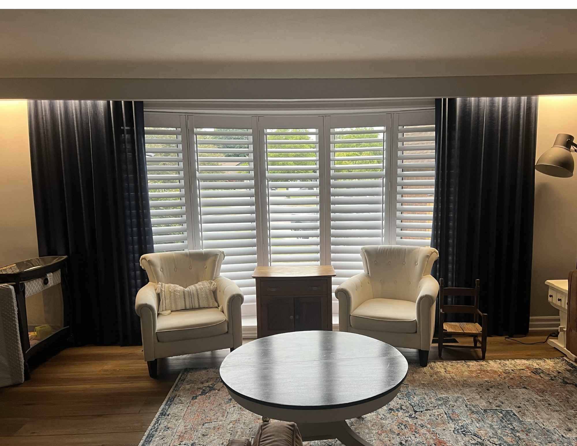 living room with shutters and drapery